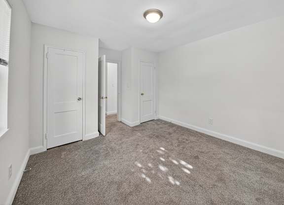 A room with carpeted floor and white walls.
