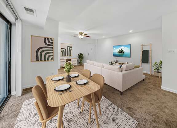 A modern dining room with a wooden table and chairs.