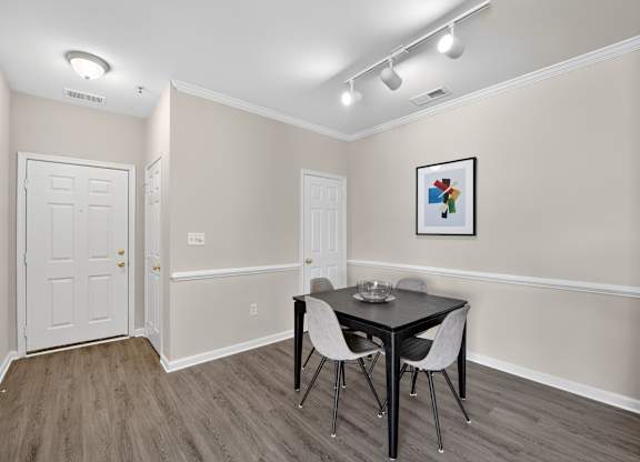 A classic style dining room with a table and chairs.