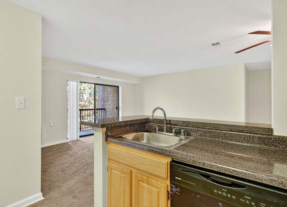 A kitchen with a sink and a dishwasher.