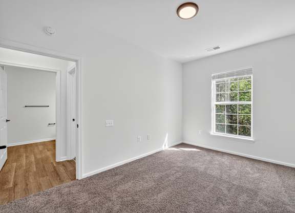 Renovated bedroom with carpet and ceiling fan