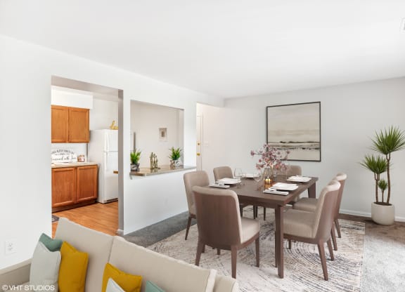 a living room and dining room with a table and chairs