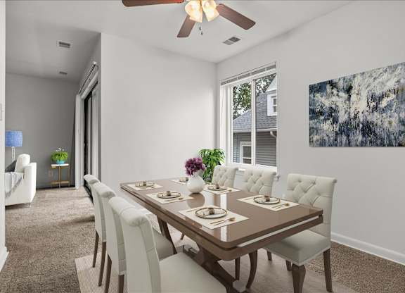 a dining room with a table and chairs and a ceiling fan