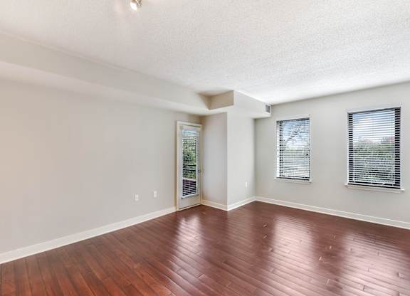 A room with wooden floors and white walls.