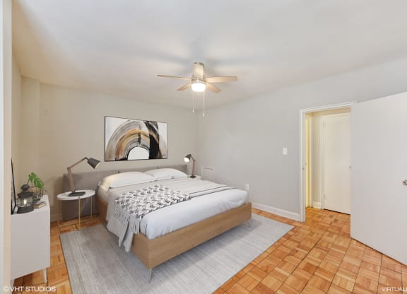 a bedroom with a bed and a ceiling fan at The Chesapeake, Washington