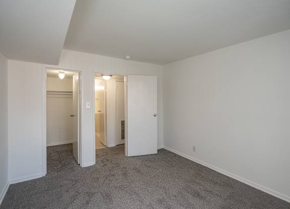 A room with carpeted floor and white walls.
