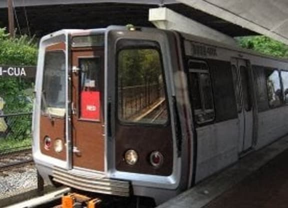 a train that is sitting on the tracks at Brookland Ridge Apartments, Washington DC
