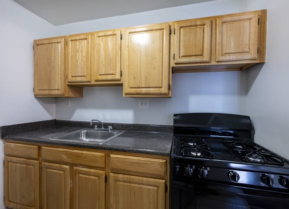 Full Kitchen with Wood Cabinets and Black appliances
