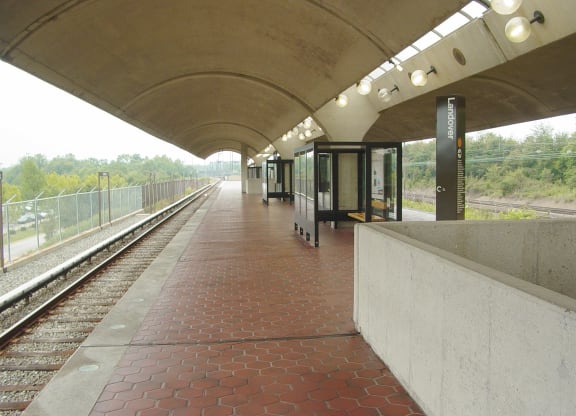 a train station with a train on the tracks
