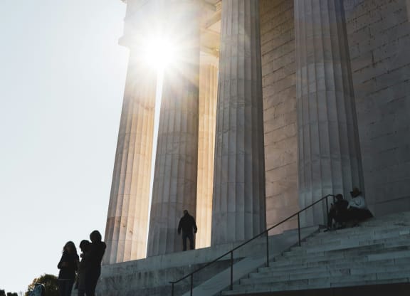 people standing on the steps of the memorial