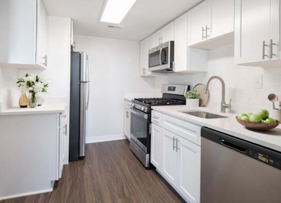 A modern kitchen with a black refrigerator and stove.