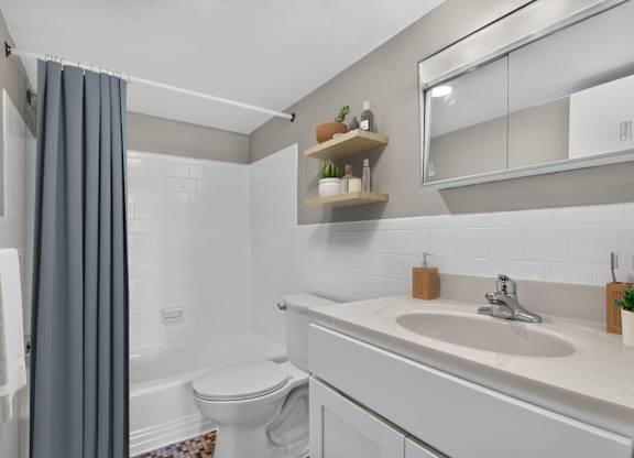 A bathroom with a white toilet and a white sink.
