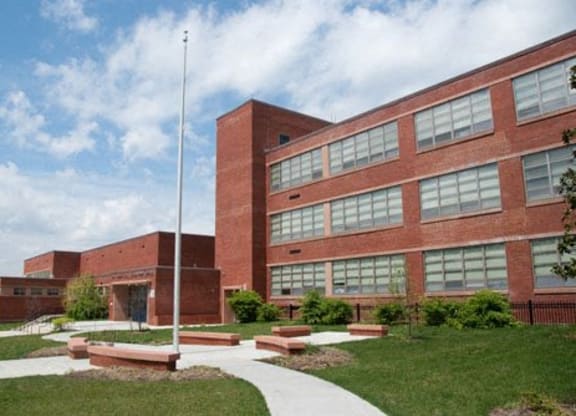 a large brick building with a flagpole in front of it