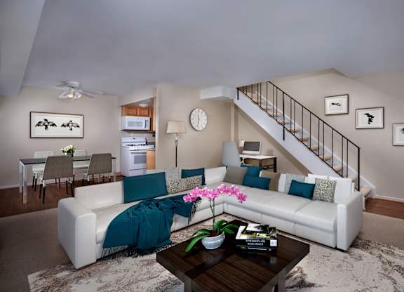 a living room with a white couch and a coffee table