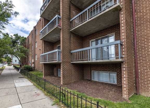 our apartments are located in a brick building with a sidewalk
