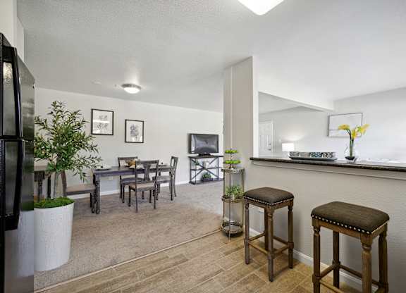 A kitchen with a table and chairs.