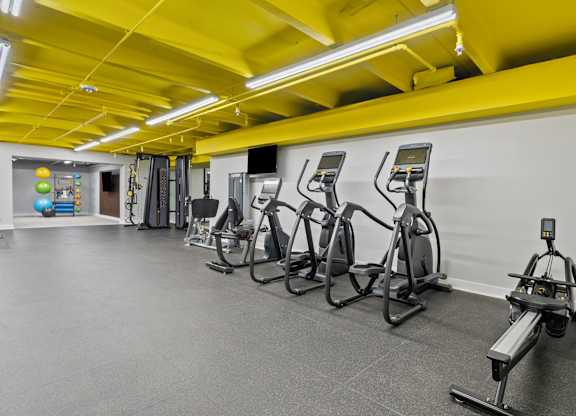 A gym with treadmills and exercise bikes.