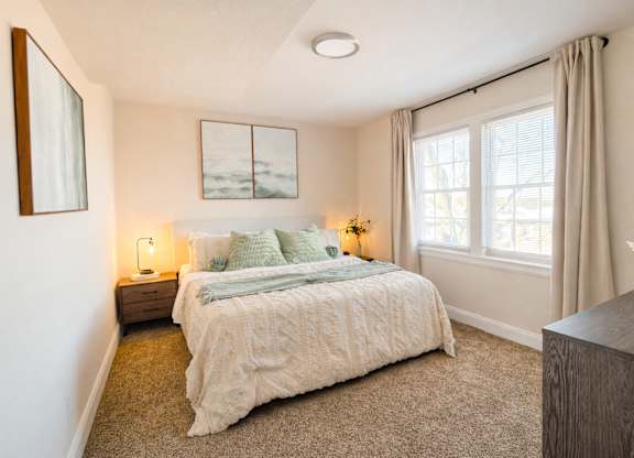 Bedroom with neutral tones and large windows at Highland Ridge Apartments, Capitol Heights, 20743