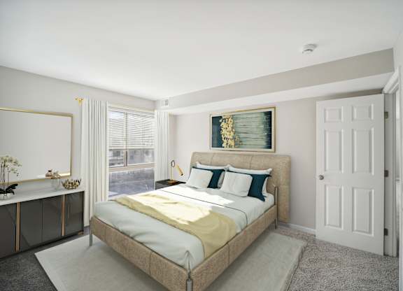A bedroom with a large bed and a mirror on the wall.