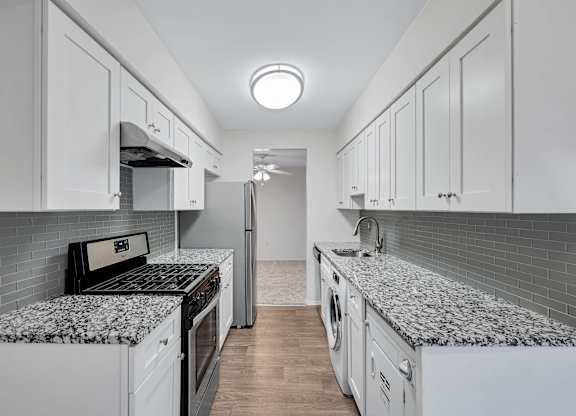 Kitchen with refrigerator and white cabinets at Aspen at Lake Trail, Maryland, 21045