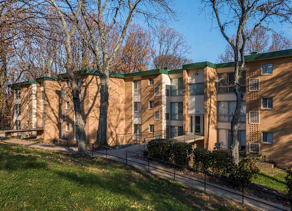 Apartment building with a green roof and a sign on the front.