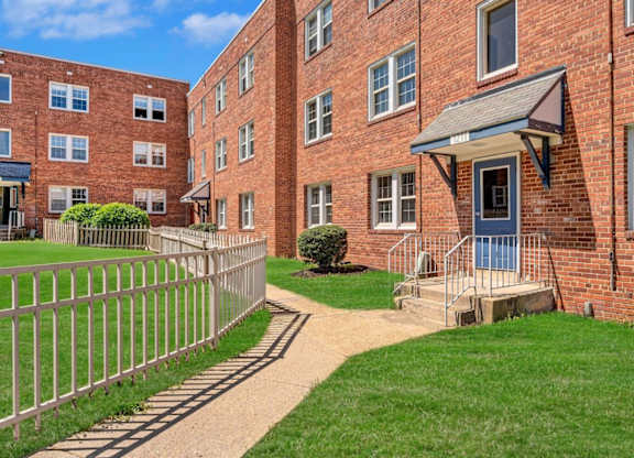 Brick apartment building exterior with courtyard at Highland Ridge Apartments, Capitol Heights