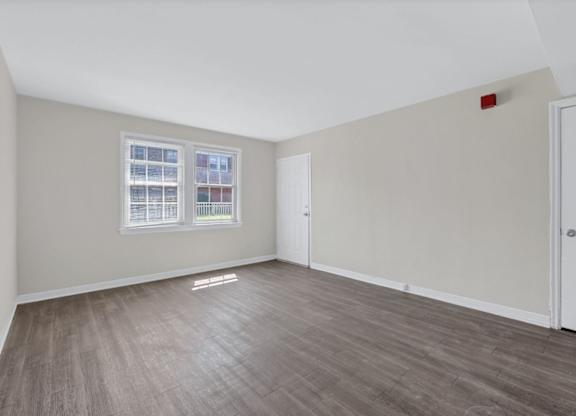 Empty bedroom with laminate flooring and closet at Highland Ridge Apartments, Capitol Heights, MD