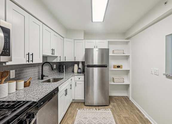 White Cabinetry And Appliances In Kitchen at Aspen at Lake Trail, Columbia, MD