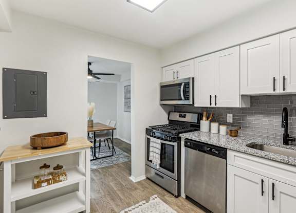 Modern kitchen with stainless steel appliances and white cabinets at Aspen at Lake Trail, Maryland, 21045