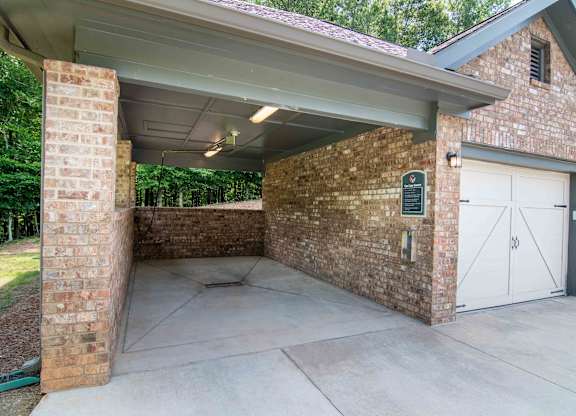 the garage of a house with white doors and a cement driveway at Century New Holland, Gainesville, GA
