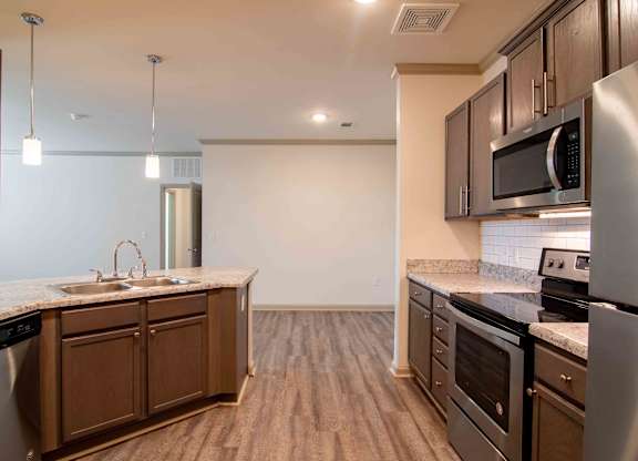 a kitchen with stainless steel appliances and a counter top at Century New Holland, Gainesville, Georgia