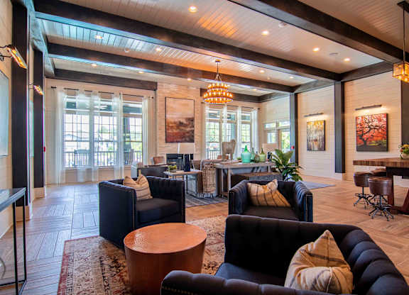 a living room with couches and chairs and a table at Century New Holland, Gainesville, GA, 30501
