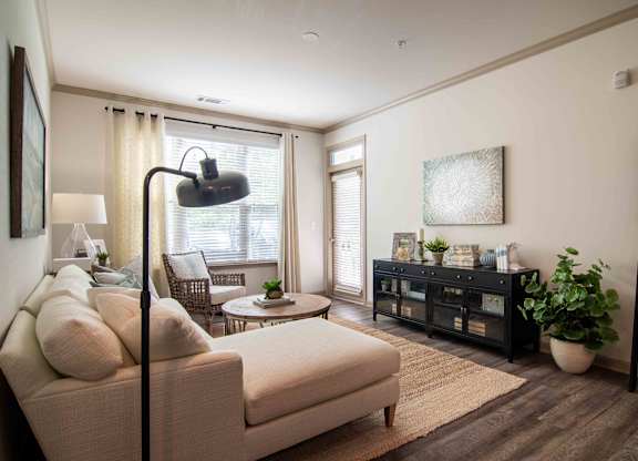 a living room with a couch and a table  at Century New Holland, Gainesville, 30501