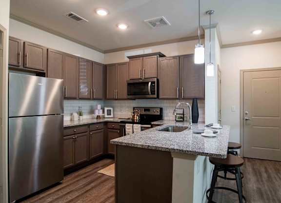 a kitchen with stainless steel appliances and granite counter tops at Century New Holland, Gainesville, GA, 30501