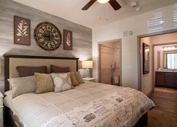 a bedroom with a large bed and a clock on the wall at Century New Holland, Georgia