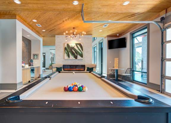 a pool table with balls on it in a large room with a fireplace at Century Town Center, Florida