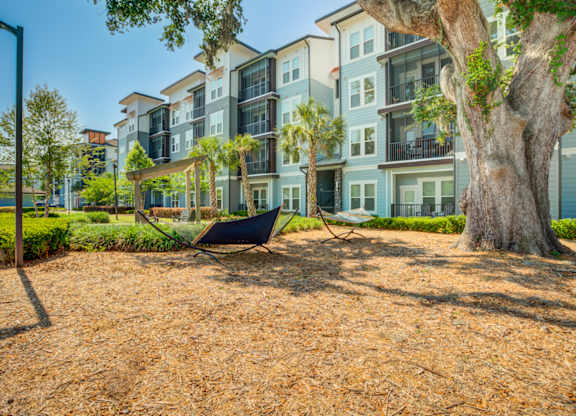 a hammock on the ground in front of an apartment building at Century Town Center, Gainesville