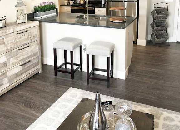 A modern kitchen with a bar stool in front of the island.at Century Baxter Avenue, Kentucky, 40204