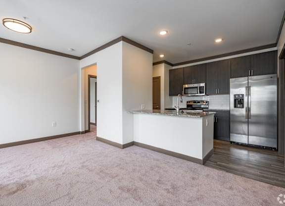 A kitchen with a white counter and stainless steel appliances. at Century Belmont Station, Louisville, KY