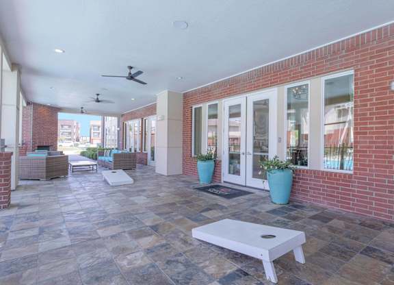 a patio with a white coffee table in front of a brick building at Century Palm Bluff, Portland