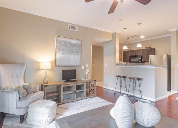 a living room with a couch and a chair at Century South Shore, League City, TX