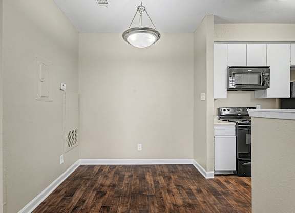 A kitchen area with a dishwasher and microwave.