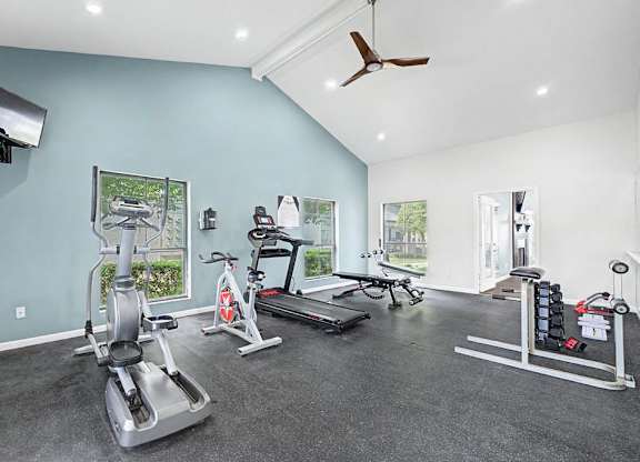 A spacious home gym with a variety of exercise equipment.