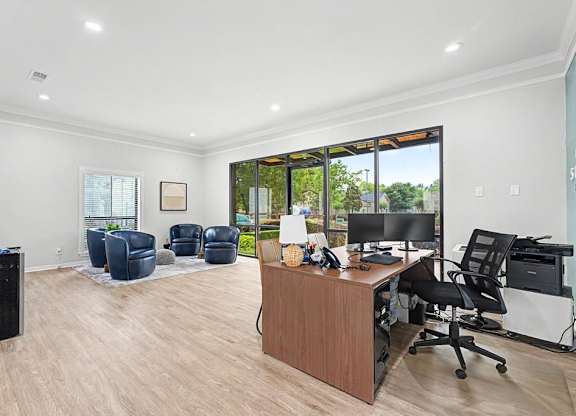 A spacious office with a reception desk and multiple chairs.