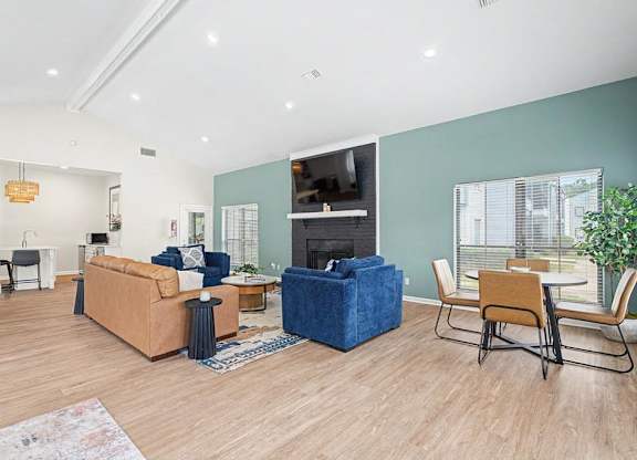 A living room with a blue sofa and a wooden floor.