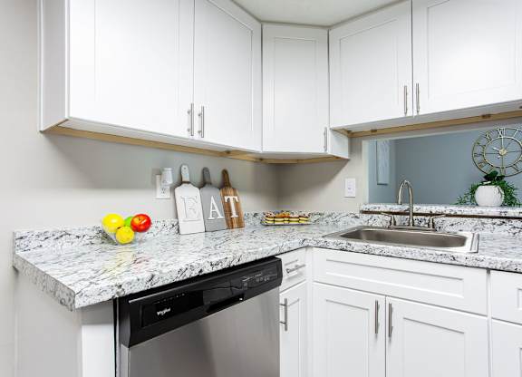 Kitchen with white cabinets and granite countertops at The Cobb Apartments-Townhomes, Austell, GA, Georgia, 30168