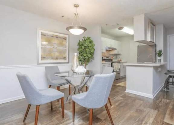 a dining room and kitchen with a table and chairs at The Sapphire, Decatur, GA, 30035