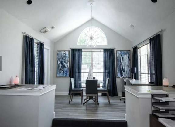 a white living room with a table and chairs and a window at The Sapphire, Decatur, Georgia