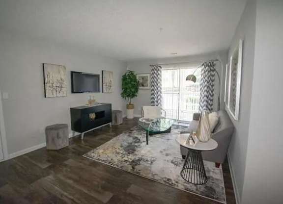 a living room with a couch and a television at The Sapphire, Georgia, 30035