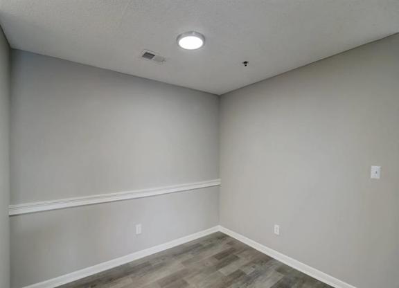 the interior of a room with white walls and wood floors at The Sapphire, Decatur, GA, 30035
